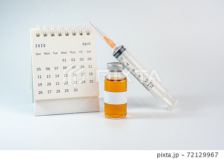 Blank label vaccine bottle and 2020 calendar on white background 72129967