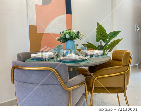 Furnished dining table with tableware in modern house Furnished dining table with tableware in modern house 72130001