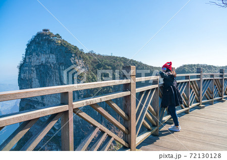 Female tourist enjoying beautiful landscape on Tianmen Mountain 72130128