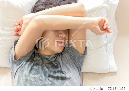 Top view asian woman sleeping with her hand on forehead. Top view asian woman sleeping with her hand on forehead. 72134195