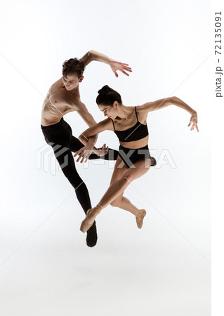 Young and graceful ballet dancers in minimal black style isolated on white studio background 72135091