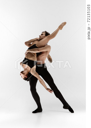 Young and graceful ballet dancers in minimal black style isolated on white studio background Young and graceful ballet dancers in minimal black style isolated on white studio background 72135103