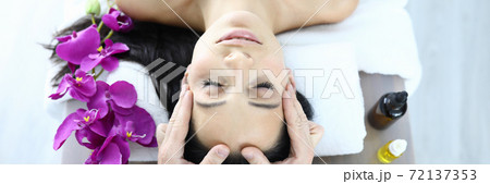 Portrait of woman who is being massaged closeup Portrait of woman who is being massaged closeup 72137353