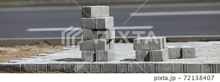 Road repair and paving slabs laying closeup. 72138407
