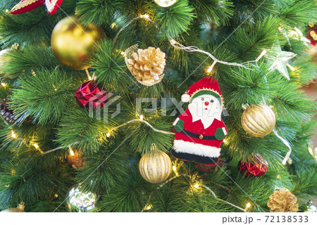 Christmas tree with golden balls and Santa Claus decoration for seasonal festival holiday Christmas tree with golden balls and Santa Claus decoration for seasonal festival holiday 72138533