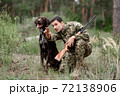 Man with Rifle and Pointer Dog Hunting for Rabbit. 72138906