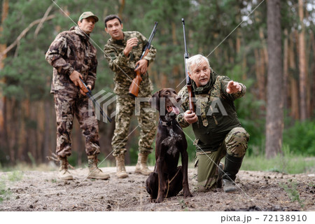 Man Hunter Pointing Somewhere for Hunting Dog. Man Hunter Pointing Somewhere for Hunting Dog. 72138910