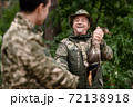 Happy Hunter Man Shows Fetched Wild Duck to Son. 72138918