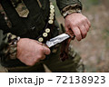 Brutal Hunting Knife in Professional Hunter Hands. 72138923
