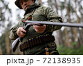 Experienced Hunter Charges Shotgun in Forest. 72138935