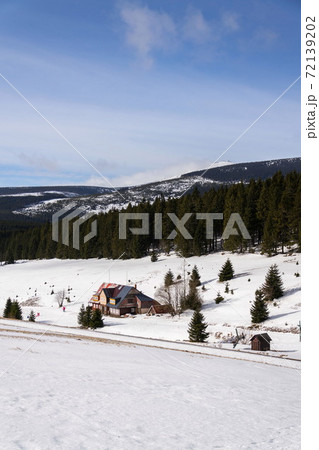 Snezka, the highest mountain in the Czech Republic, Krkonose Mountains, snowy winter day, Polish meteo observatory and Czech post office Postovna seen on top Snezka, the highest mountain in the Czech Republic, Krkonose Mountains, snowy winter day, Polish meteo observatory and Czech post office Postovna seen on top 72139202