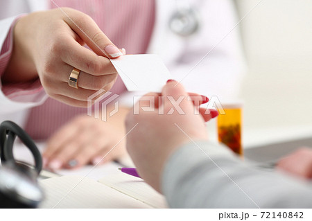 Female physician hand give white blank 72140842