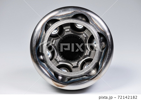 Close-up of a new CV joint on a gray background. Car suspension parts Close-up of a new CV joint on a gray background. Car suspension parts 72142182