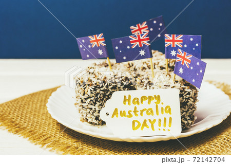Iconic traditional Australian party food, Lamington cakes on a red, white and blue background. Iconic traditional Australian party food, Lamington cakes on a red, white and blue background. 72142704