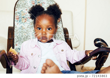 little cute african american girl playing with animal toys at home, pretty adorable princess in interior happy smiling, lifestyle real people concept little cute african american girl playing with animal toys at home, pretty adorable princess in interior happy smiling, lifestyle real people concept 72143863