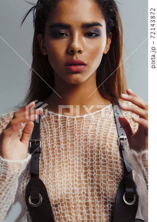 young pretty african woman with fashion makeup and clothers posing sensual on white background, lifestyle people concept 72143872