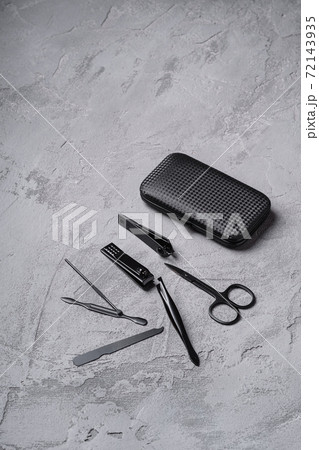 Set of manicure, pedicure tools and accessories with case, stone concrete background, angle view Set of manicure, pedicure tools and accessories with case, stone concrete background, angle view 72143935