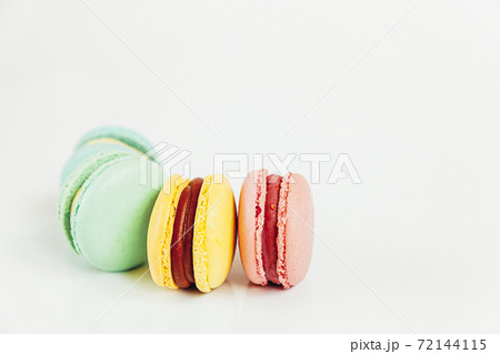Sweet almond colorful pastel pink blue yellow green macaron or macaroon dessert cake isolated on white background. French sweet cookie. Minimal food bakery concept. Flat lay top view, copy space Sweet almond colorful pastel pink blue yellow green macaron or macaroon dessert cake isolated on white background. French sweet cookie. Minimal food bakery concept. Flat lay top view, copy space 72144115