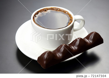 white cup with black coffee and chocolate on the saucer white cup with black coffee and chocolate on the saucer 72147304