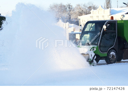 Special snow machine clears snow on the city street 72147426