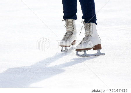 feet skating on the ice rink 72147435