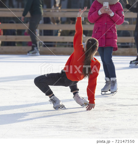 girl is photographed on an ice skating rink. Hobbies and winter vacations 72147550