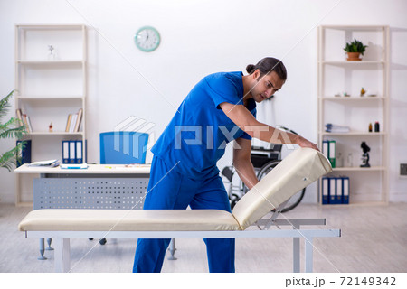 Young male doctor working in the clinic 72149342