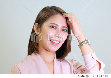 前髪を触る女性の写真素材
