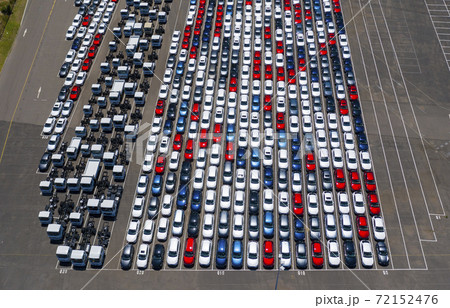 Aerial photo of new passenger cars and trucks at a shipping port in Australia 72152476