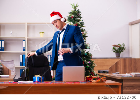 Employee in the office during christmas party Employee in the office during christmas party 72152700