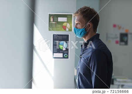 Caucasian man wearing mask in an office Caucasian man wearing mask in an office 72156666