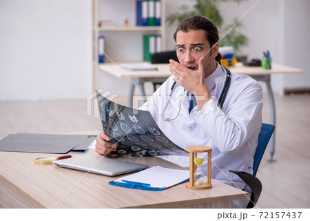 Young male doctor in time management concept Young male doctor in time management concept 72157437