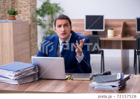 Young male employee unhappy with excessive work 72157526