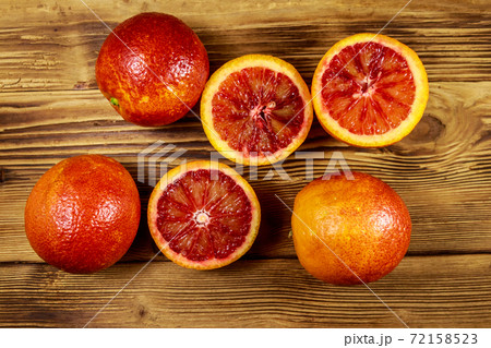 Red blood oranges on wooden table. Top view 72158523