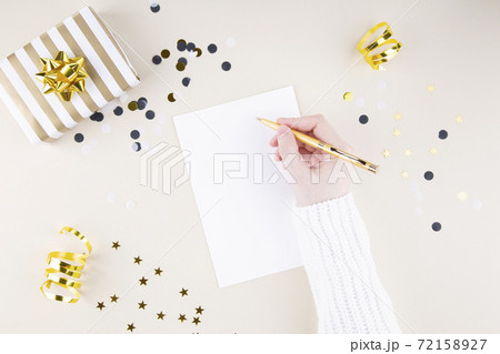 Holiday attributes. Girl writes plans for the new year. Top view. Copy space Holiday attributes. Girl writes plans for the new year. Top view. Copy space 72158927