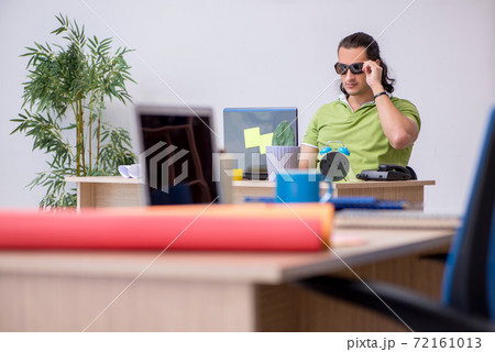 Young male designer working in the office 72161013