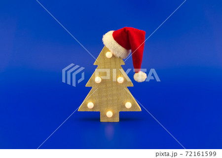 Christmas tree with red Santa hat Christmas tree with red Santa hat 72161599