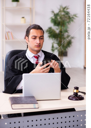 Young male lawyer working in the courthouse 72164438