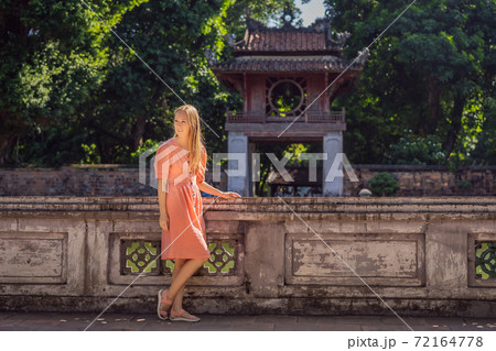 Woman tourist in Temple of Literature in Hanoi in Southeast Asia, Vietnam. Temple of Confucius in Vietnamese capital. Vietnam reopens after coronavirus quarantine COVID 19 Woman tourist in Temple of Literature in Hanoi in Southeast Asia, Vietnam. Temple of Confucius in Vietnamese capital. Vietnam reopens after coronavirus quarantine COVID 19 72164778