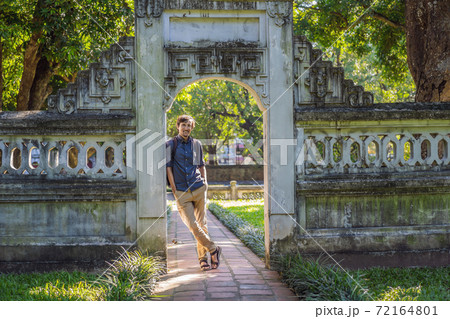 Man tourist in Temple of Literature in Hanoi in Southeast Asia, Vietnam. Temple of Confucius in Vietnamese capital. Vietnam reopens after coronavirus quarantine COVID 19 Man tourist in Temple of Literature in Hanoi in Southeast Asia, Vietnam. Temple of Confucius in Vietnamese capital. Vietnam reopens after coronavirus quarantine COVID 19 72164801