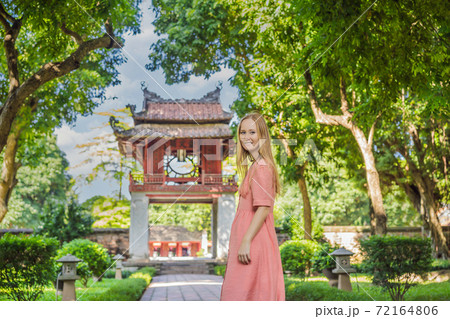 Woman tourist in Temple of Literature in Hanoi in Southeast Asia, Vietnam. Temple of Confucius in Vietnamese capital. Vietnam reopens after coronavirus quarantine COVID 19 Woman tourist in Temple of Literature in Hanoi in Southeast Asia, Vietnam. Temple of Confucius in Vietnamese capital. Vietnam reopens after coronavirus quarantine COVID 19 72164806