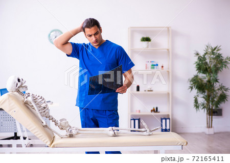 Young male radiologist doctor and skeleton patient Young male radiologist doctor and skeleton patient 72165411