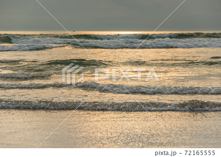 Scenery of soft waves on the beach at late evening 72165555
