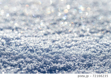 Snow crystals illuminated by sunlight. Winter background. Snow crystals illuminated by sunlight. Winter background. 72166235