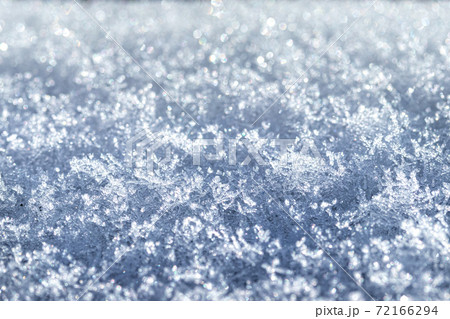 Snow crystals illuminated by sunlight. Winter background. 72166294