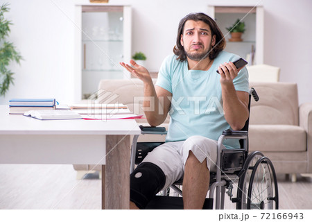Young student in wheel-chair studying at home Young student in wheel-chair studying at home 72166943