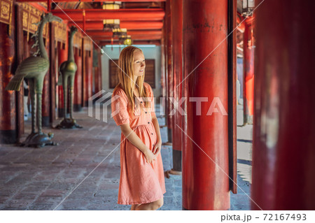 Woman tourist in Temple of Literature in Hanoi in Southeast Asia, Vietnam. Temple of Confucius in Vietnamese capital. Vietnam reopens after coronavirus quarantine COVID 19 Woman tourist in Temple of Literature in Hanoi in Southeast Asia, Vietnam. Temple of Confucius in Vietnamese capital. Vietnam reopens after coronavirus quarantine COVID 19 72167493