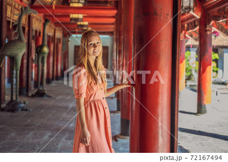 Woman tourist in Temple of Literature in Hanoi in Southeast Asia, Vietnam. Temple of Confucius in Vietnamese capital. Vietnam reopens after coronavirus quarantine COVID 19 Woman tourist in Temple of Literature in Hanoi in Southeast Asia, Vietnam. Temple of Confucius in Vietnamese capital. Vietnam reopens after coronavirus quarantine COVID 19 72167494