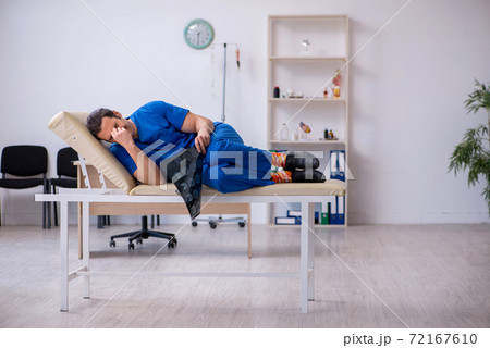 Young male doctor radiologist being unhappy after night shift 72167610