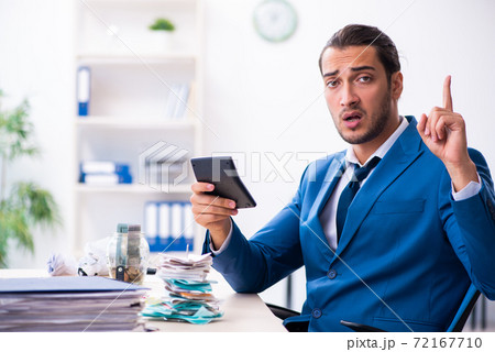 Young male accountant in budget planning concept Young male accountant in budget planning concept 72167710